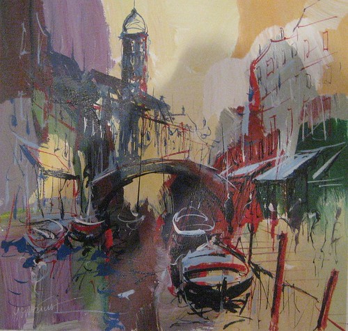 Boats under a bridge between muted canal buildings