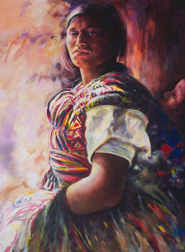Seated woman against a warm dark background