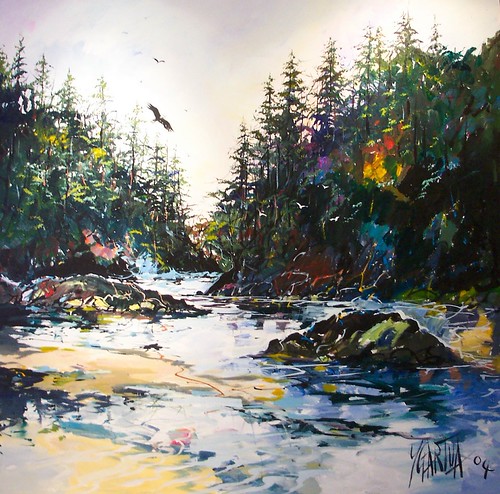 Stream and rocks between evergreen banks