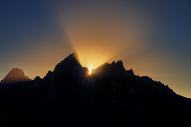 Last rays of sun behind Grand Teton Mountains