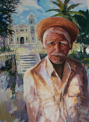 Man in a head wrap before historic buildings