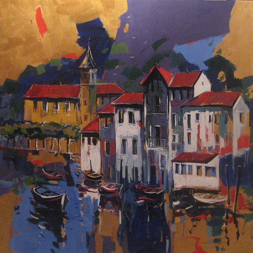 Waterfront houses reflected in dark blue water