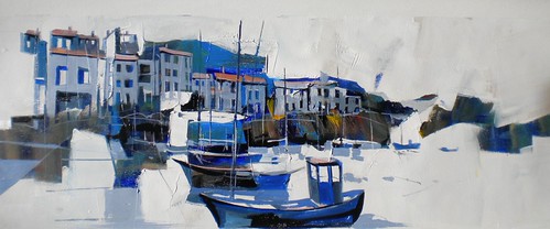 Blue fishing boat beside pale waterfront houses