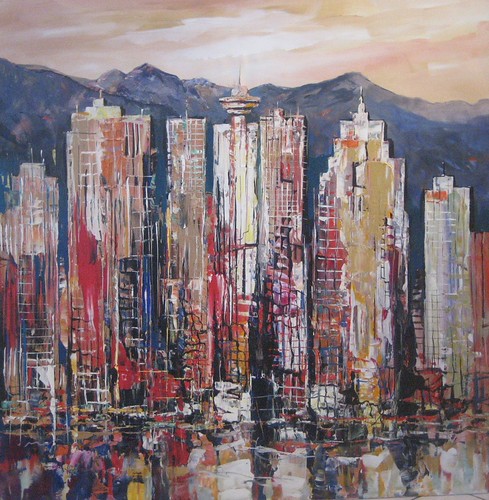 Dense city towers backed by mountains
