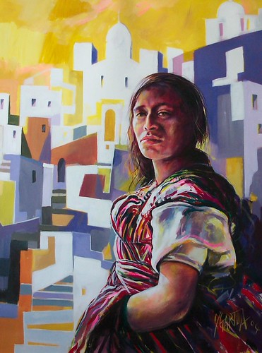 Seated woman before blue and white buildings