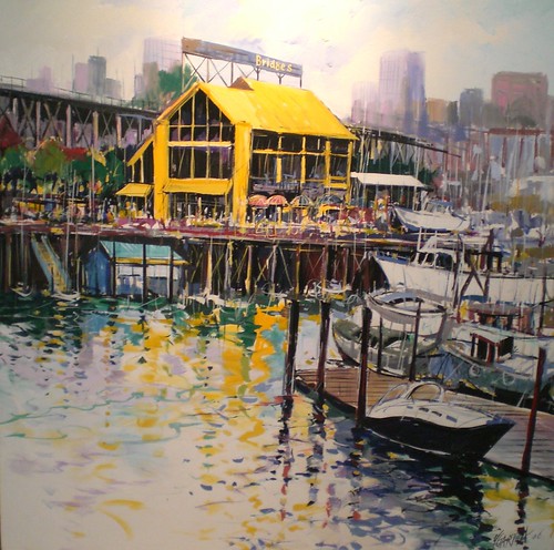 Yellow waterfront building beside moored boats