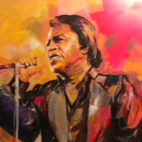 Singer at a microphone on a warm orange background