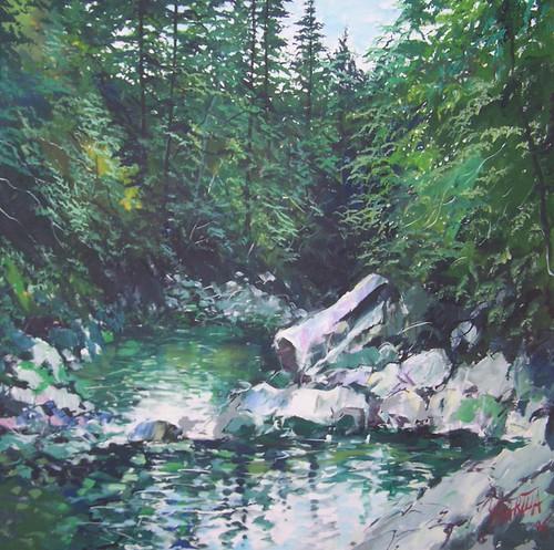 Rocky creek enclosed by green foliage