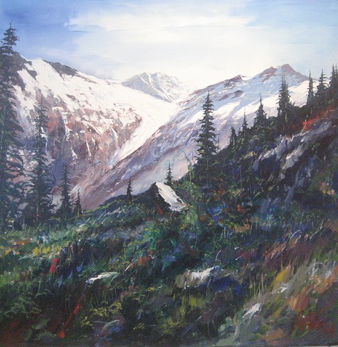 Snow-covered peaks above a flowered hillside