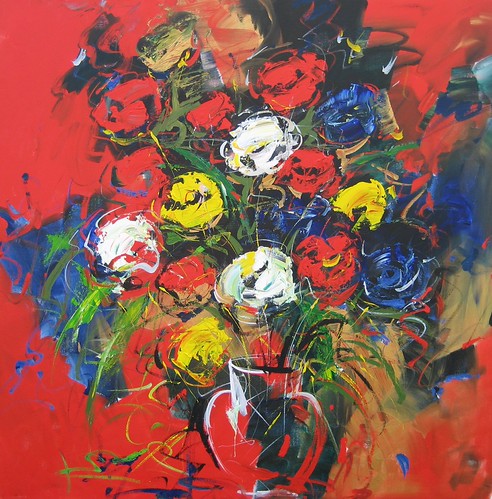Mixed flowers in a vase on a red background