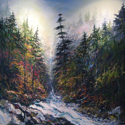 Waterfall descending through evergreen forest