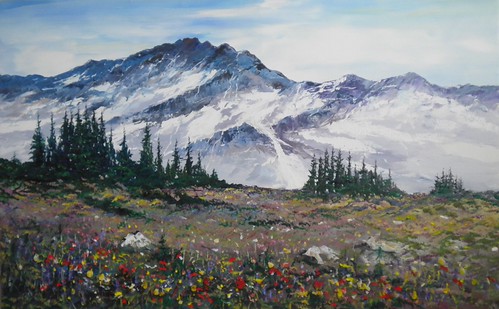 Snow-covered mountains above spring flowers