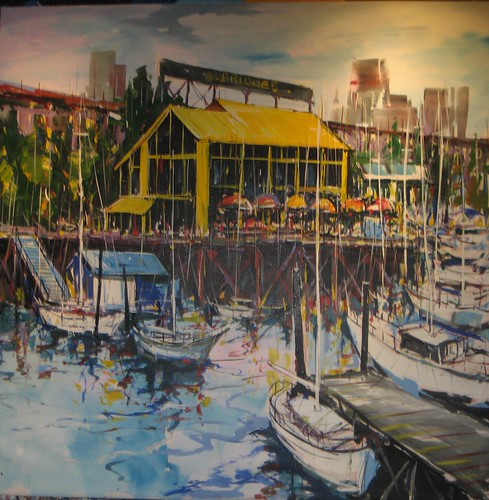 Yellow waterfront building and marina reflections