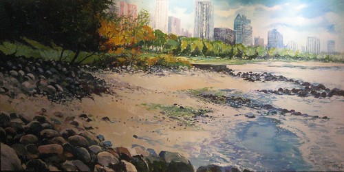 Rocky beach with city buildings behind