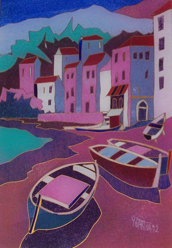 Small boats beside colourful waterside buildings