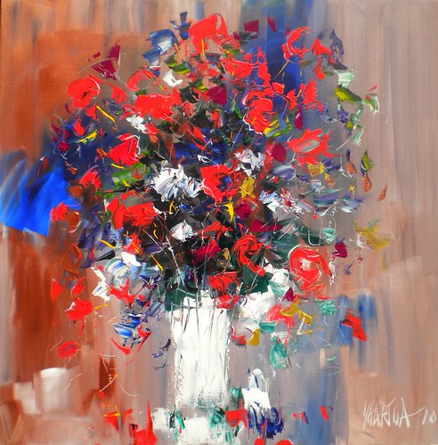 Red and blue bouquet in a white vase