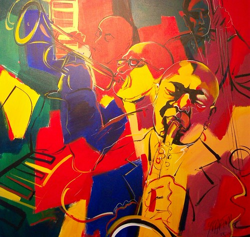 Musicians and instruments outlined across red and yellow blocks