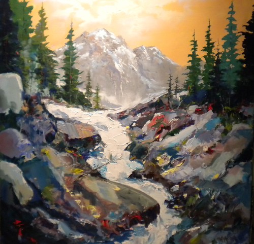 Snowy stream beneath mountains and evergreens