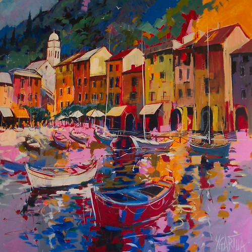 Fishing boats beneath warm waterfront buildings