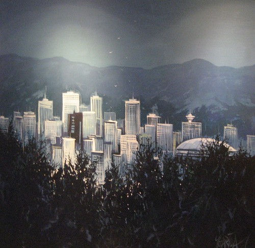 City towers beyond dark evergreen silhouettes