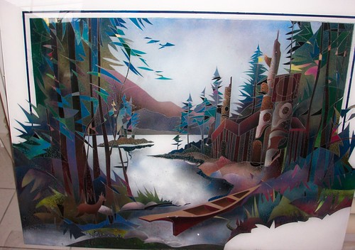 Forest river bordered by carved poles and trees