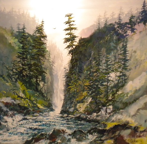 Waterfall dropping between forested cliffs