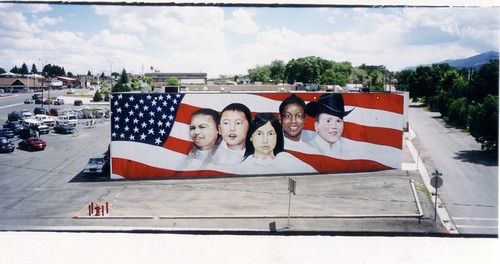 Building rooftop with a children's portrait mural