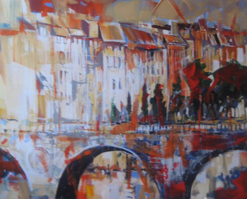 Arched bridge beneath pale waterfront buildings