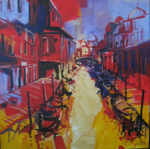 Bright canal with boats and red buildings