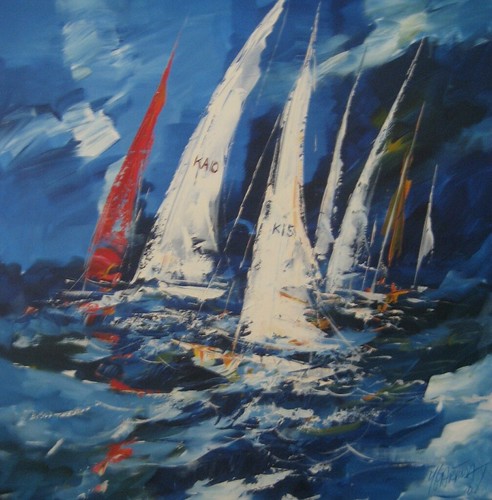 White and red sailboats on choppy blue water
