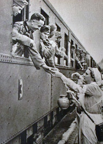 German Red Cross nurses handing out water to German soldiers on a troop train