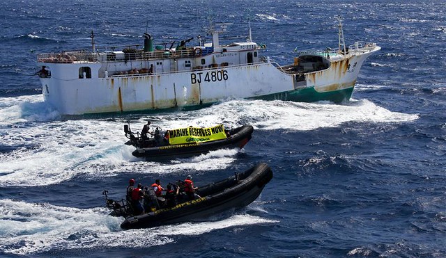 A crew of five activists aboard a Greenpeace inflatable display banners in Taiwanese and English which read: Marine Reserves Now, alongside the Taiwanese longliner