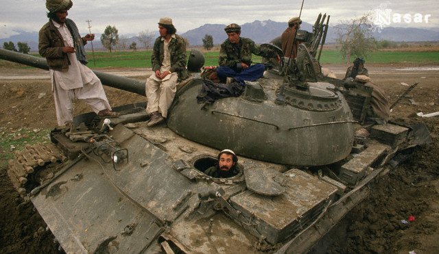 Pashtun Mujahideen sitting on a captured Russian Tank