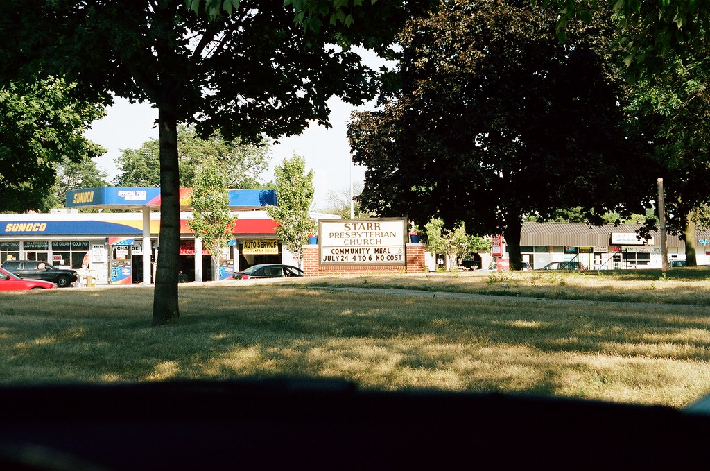 Brick sign for Starr Presbyterian Church and adjacent Sunoco gas station in Royal Oak, Michigan.