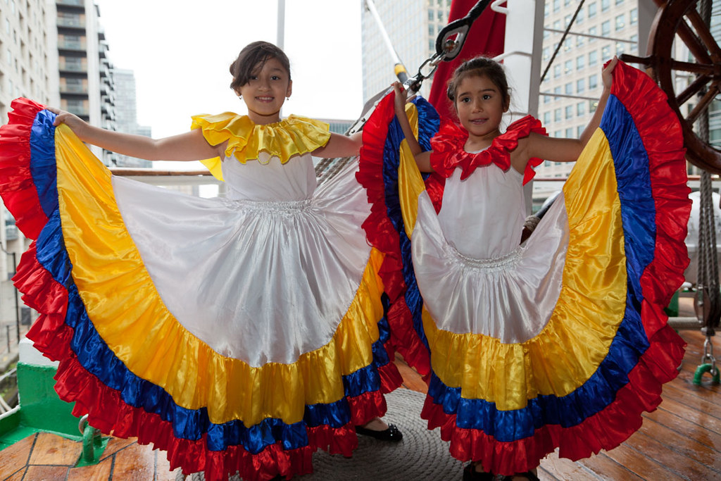 Two young girl dancers display their traditional Colombian dresses in the n...