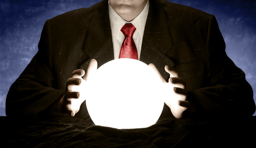 Businessman Consulting Glowing Crystal Ball
