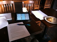 Paper, pen, HP TouchPad, coffee, scone. All important tools of the trade #academia