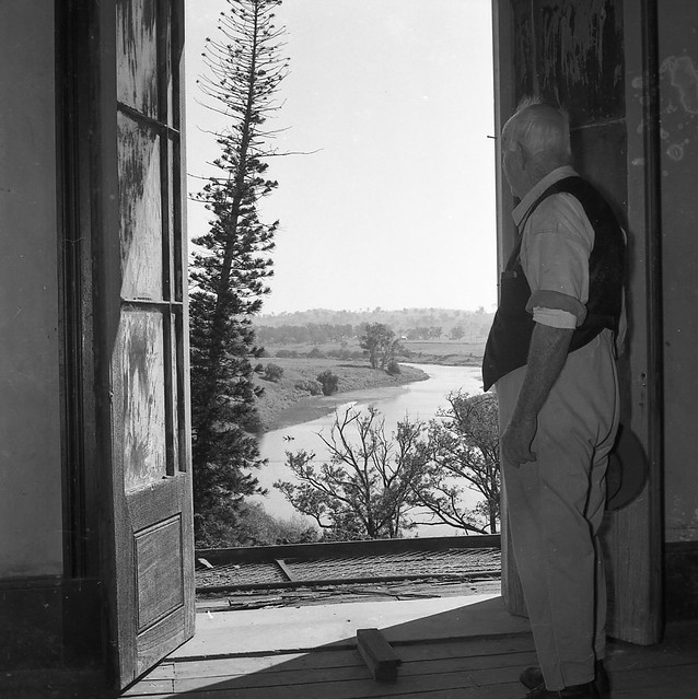 Mr. Sam McKeachie looking through upstairs window, Aberglasslyn House, Aberglasslyn, NSW, Australia - March 24, 1961