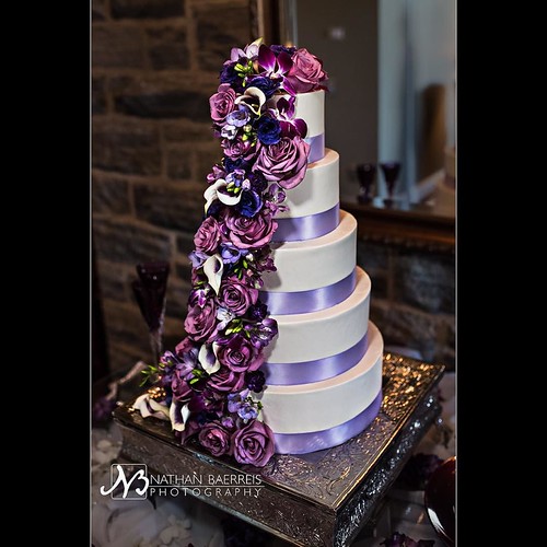A purple flower cascade down a wedding cake! This beautiful #weddingcake at Annie & Josh's wedding made me happy just to look at it! #flowersforhours #deliciousdetails #weddingdetails #beautifulwedding #romanticwedding #ashevillewedding #nikon #nathanbaer | by nathan.baerreis