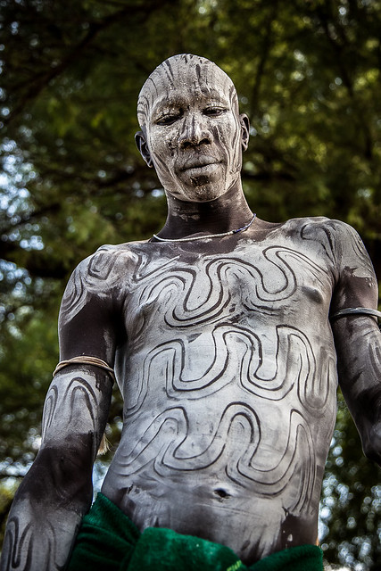 portrait of the mursi tribe man with the body painting