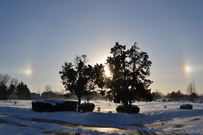 This is a photograph of Sun Dogs that was taken in -14 degree weather and was taken at a local cemetery.