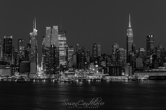 New York City Skyline In Christmas Colors BWThe New York City Skyline and the Empire State Building illuminated in red, green and white in celebration of the Christmas Holiday. The ESB antenna is lit up in red and white the colors of a candy cane. The New