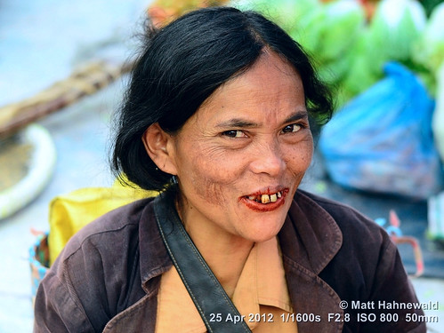 arecanut paan chewingtobacco stainedteeth travel smiling ethnic street portrait cultural character female market posing betelnut eyes face facingtheworld batak indonesia toba woman nikond3100 outdoor sumatra diversity betelstainedteeth lifestyle nikkorafs50mmf18g twothirdview person closeup clarity matthahnewald headshot colorcolour lookingatviewer colorfulcolourful