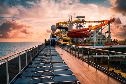Waterslides at Sea by 75CentralPhotography, The Carnival Magic‘s onboard waterpark is backlit by the rising sun just off the coast of Freeport, 
