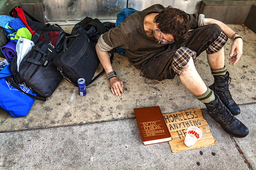 Young homeless man with world atlas--South Street
