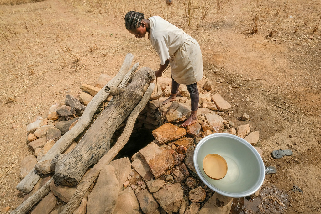 Water collection from a hand dug well near Chiana, Kassena Nankana District - Ghana.
