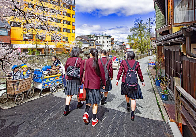 Japan 2015. Takayama. Schoolgirls looking at collective prams.