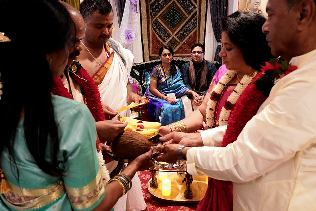 Hindu engagement ceremony, parents in foreground with priest