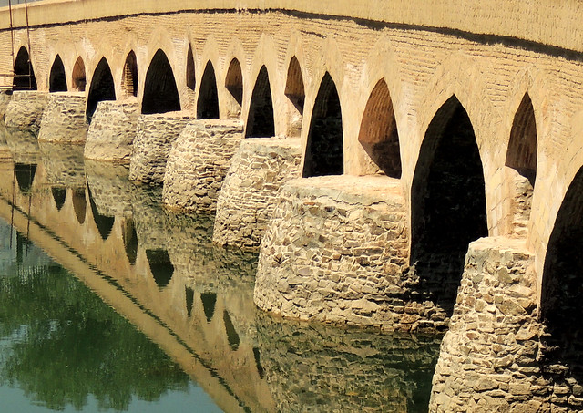 Old silk road brick bridge over Zayande river - Isfahan, Iran