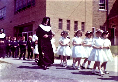 St. Francis Xavier School DC Sisters of Notre Dame de Namur with their students on First Holy Communion Day that usually happens in the 2nd Grade. Early 1960's